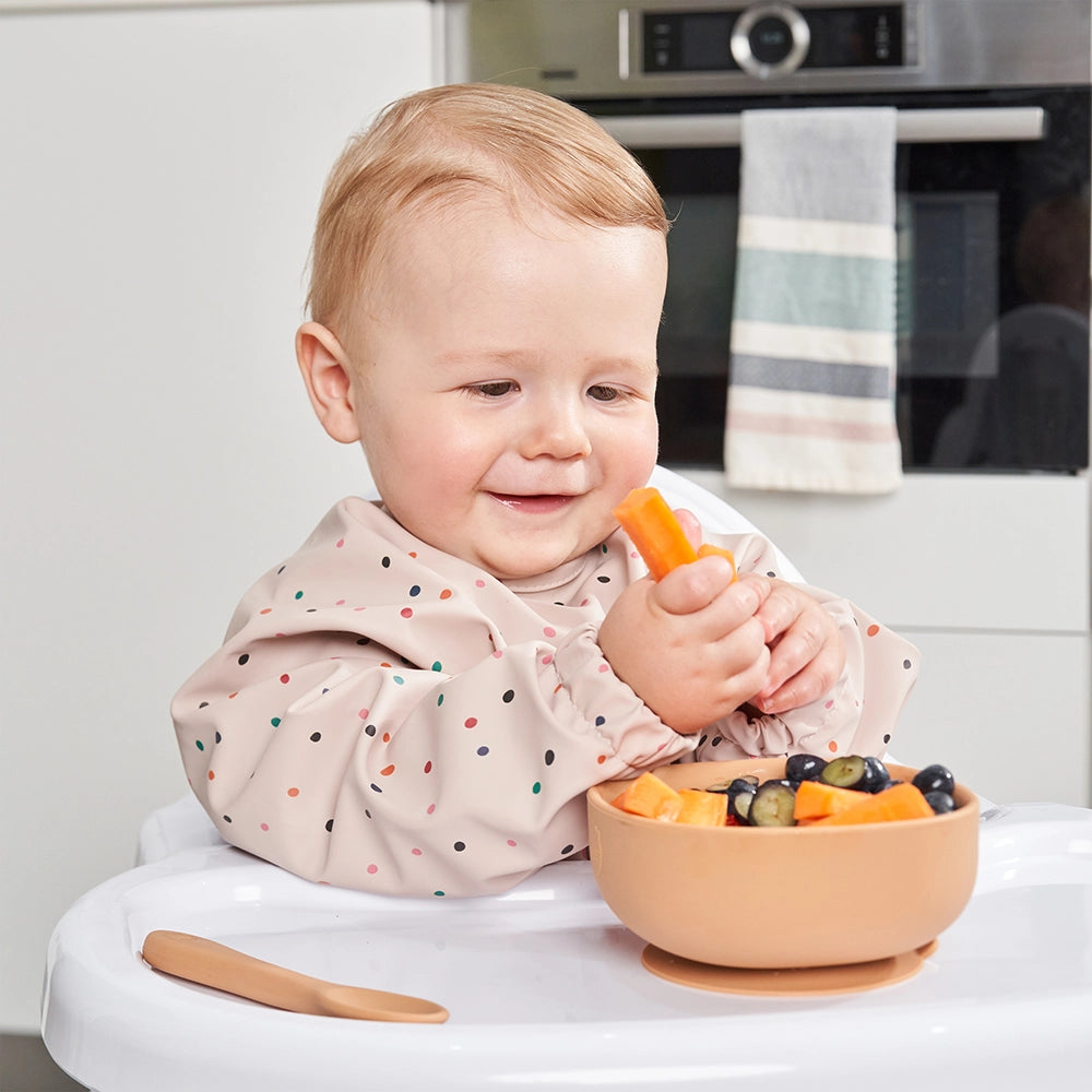 Smiling Baby in a High Chair Starting BLW With Carrots and Blueberries