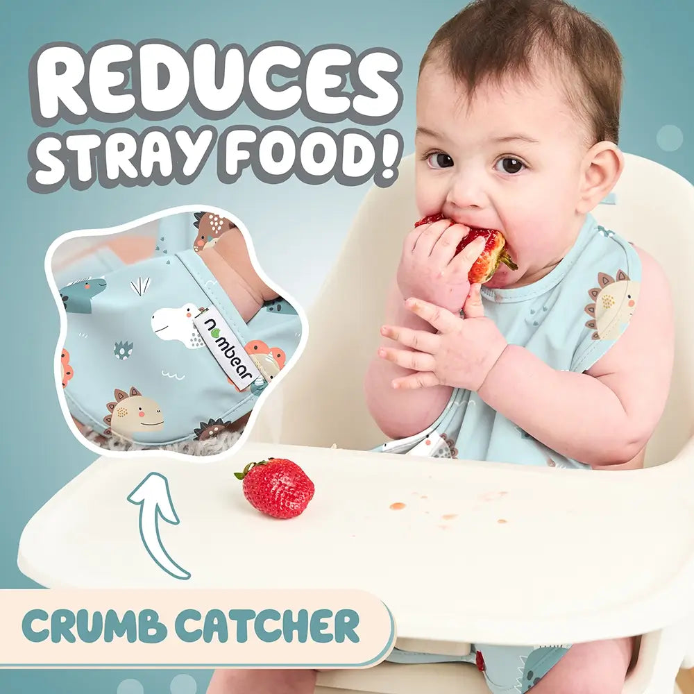 Baby Eating a Strawberry Wearing a Bib. Reduces Stray Food! With Crumb Catcher.