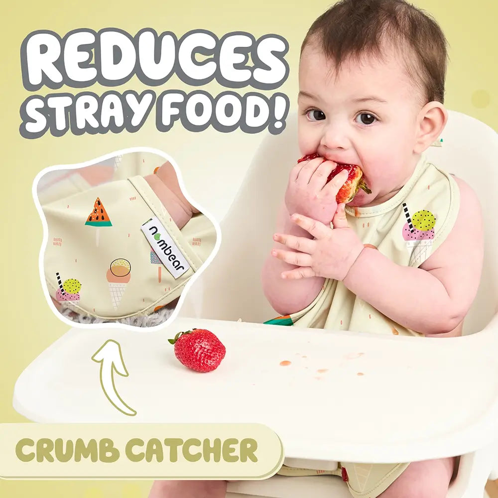 Baby Eating a Strawberry Wearing a Yellow Bib. Reduces Stray Food! With Crumb Catcher.