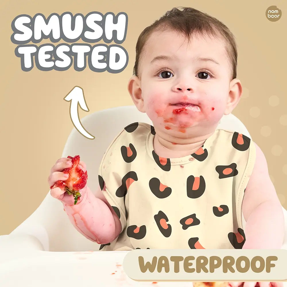 Baby Wearing a Bib with Leopard Print Pattern, Smushing a Strawberry. Smush Tested. Waterproof.