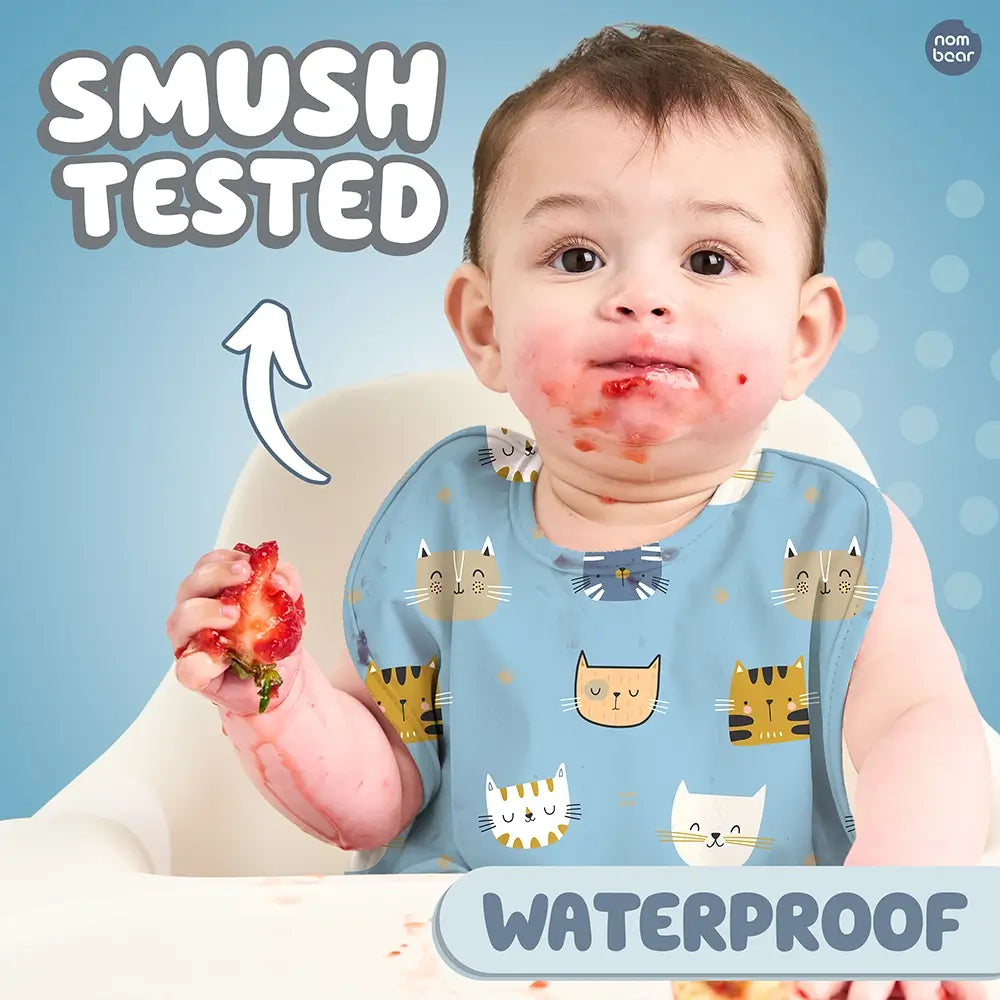 Baby Wearing a Bib with Pussycat Pattern, Smushing a Strawberry. Smush Tested. Waterproof.