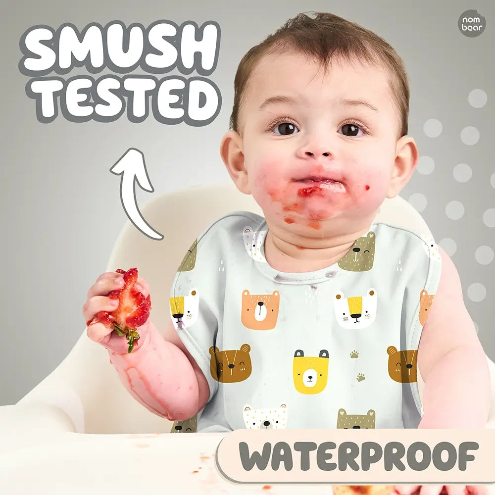 Baby Wearing a Bib with Bear Pattern, Smushing a Strawberry. Smush Tested. Waterproof.